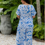 Palazzo pants in blue and white Hawaiian being worn by lady in beach resort