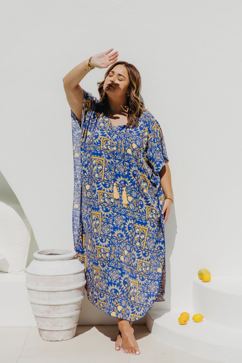 Woman wearing a Limoncello inspired Long Summer Dress enjoying dappled sunlight in Amalfi coast resort