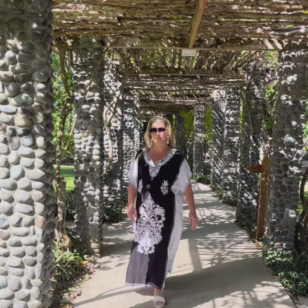 Regina wearing the Mandala Long Kaftan strolling the grounds of a Fiji resort