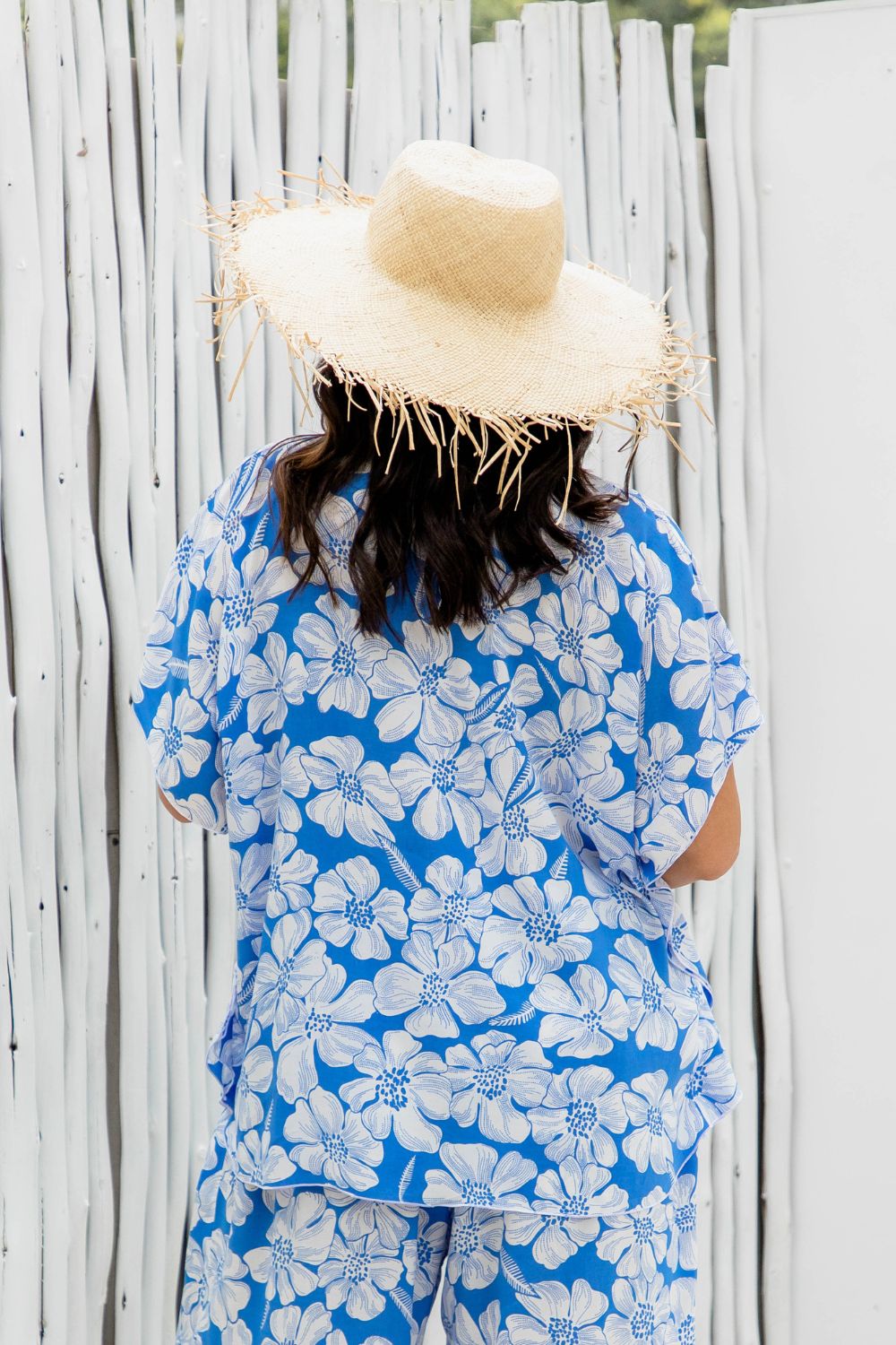 resort wear style ladies top in blue and white hibiscus floral for summer