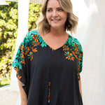 long-kaftan-dress-black-polka-orange-green-floral-close-up