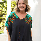 long-kaftan-dress-black-polka-orange-green-floral-close-up