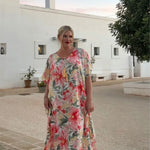 Woman wearing floral long kaftan dress on holidays in Italy