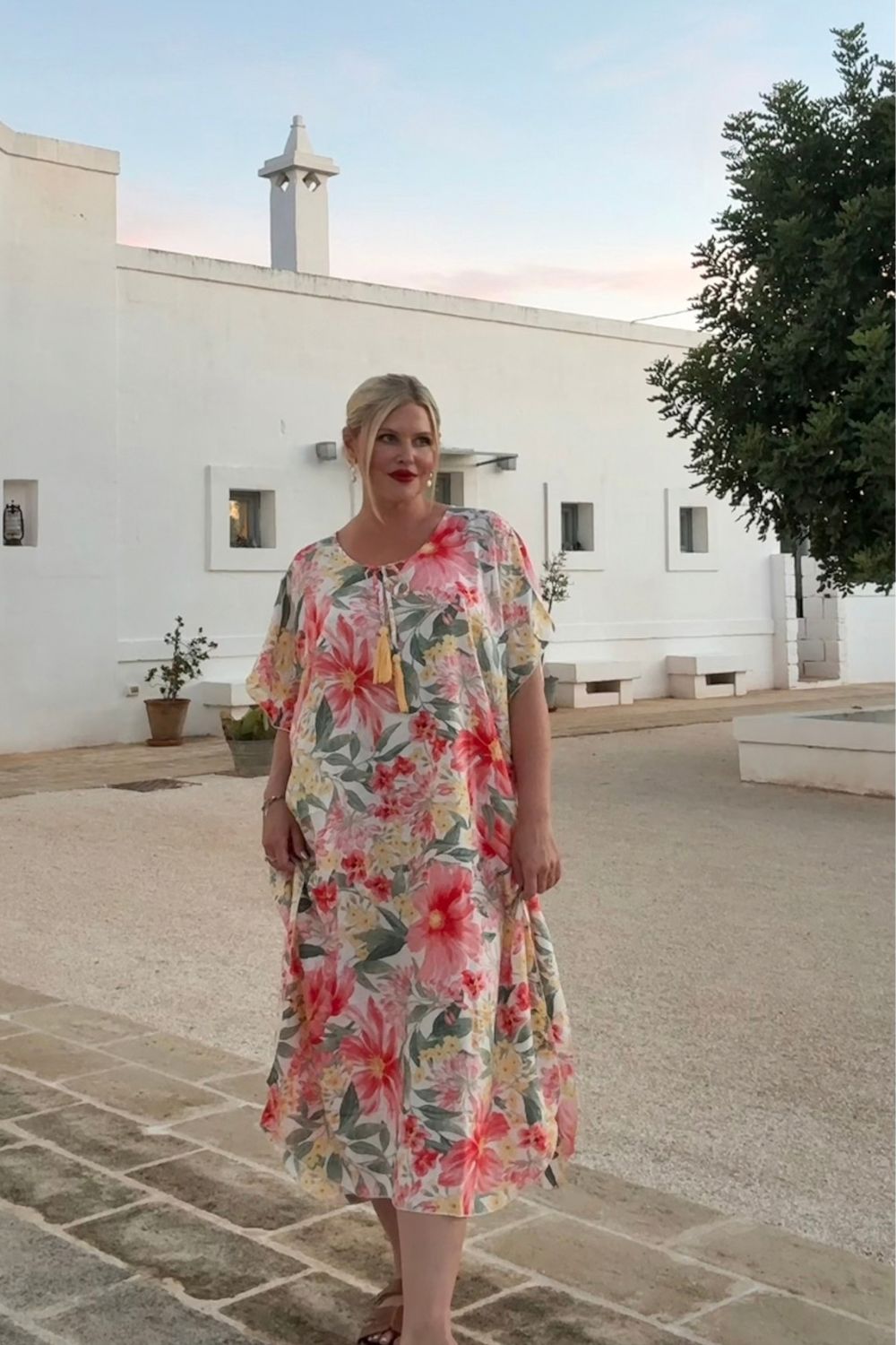 Woman wearing floral long kaftan dress on holidays in Italy