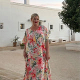 Woman wearing floral long kaftan dress on holidays in Italy