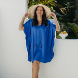 Front view of Alisha in the Lagoon Blue short kaftan dress, showing flowing kimono sleeves and tassel ties.