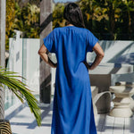 Back view of the Lagoon Blue long kaftan dress worn without a belt, showing its relaxed drape and short sleeves.