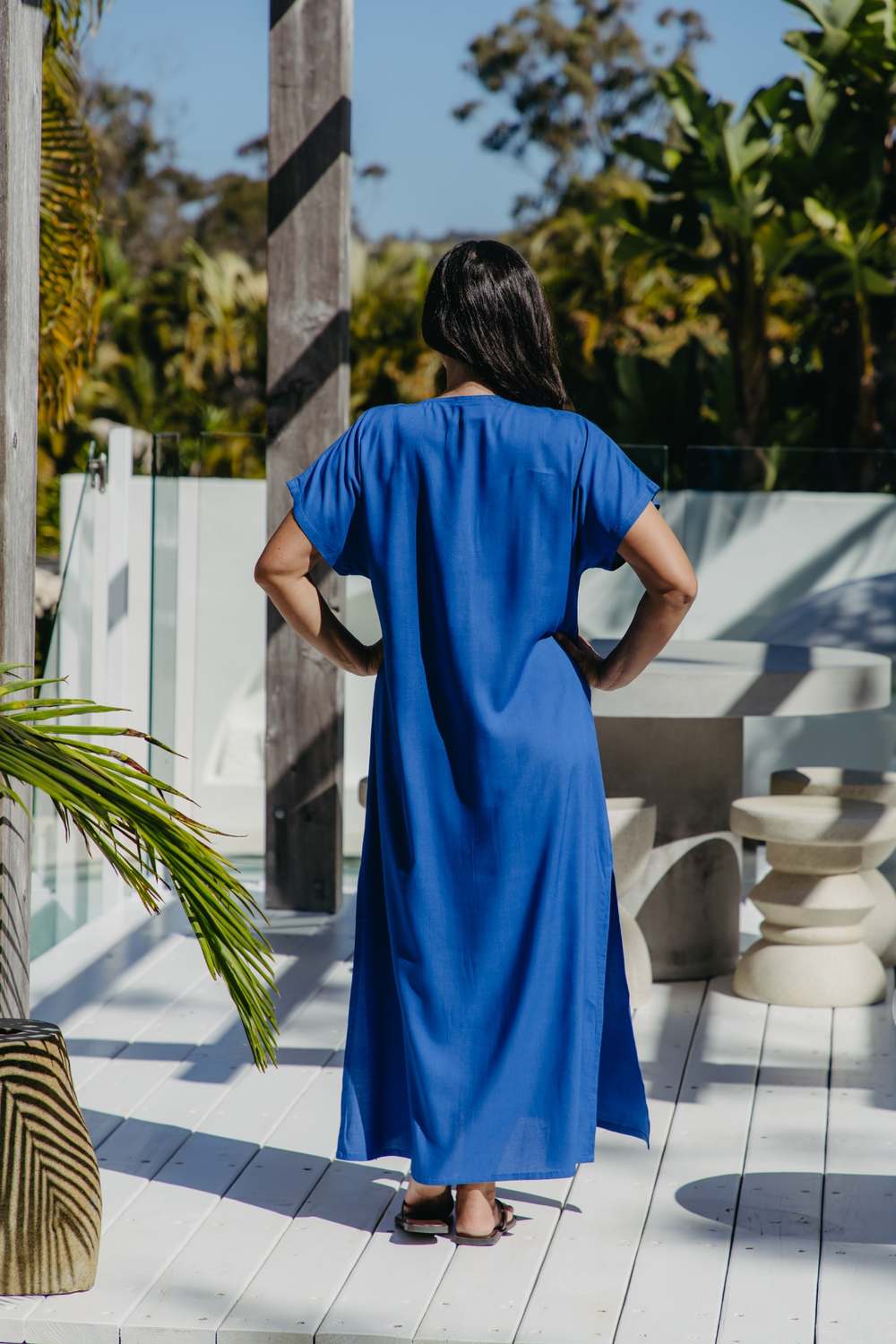 Back view of the Lagoon Blue long kaftan dress worn without a belt, showing its relaxed drape and short sleeves.