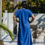 Back view of the Lagoon Blue long kaftan dress worn without a belt, showing its relaxed drape and short sleeves.