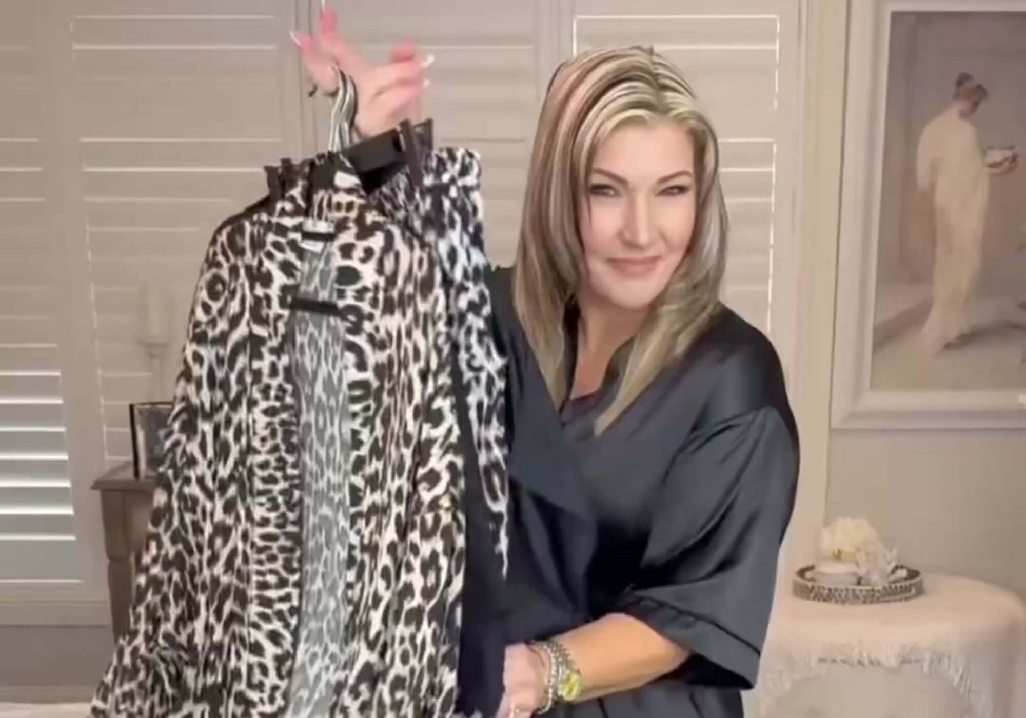 Woman-showing-how-to-pack-essential-for-tropical-holiday-with-mix-and-match-pieces-from-Holley-Day