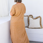 Amanda in ML Caramel Scatter dress, back view highlighting the relaxed fit and flowy silhouette