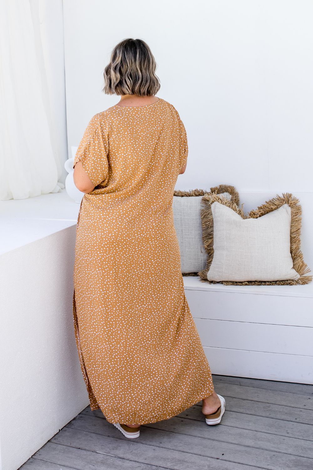 Amanda in ML Caramel Scatter dress, back view highlighting the relaxed fit and flowy silhouette