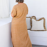 Amanda in ML Caramel Scatter dress, back view highlighting the relaxed fit and flowy silhouette