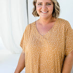 Close-up of Amanda wearing ML Caramel Scatter dress, showing detailed scatter print and soft V-neckline