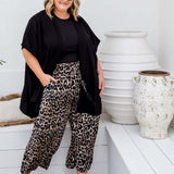 Drape detail of Black Kimono Cape in size ML showing relaxed open-front silhouette and fluid movement