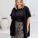 Front view of black kimono cape with relaxed open drape