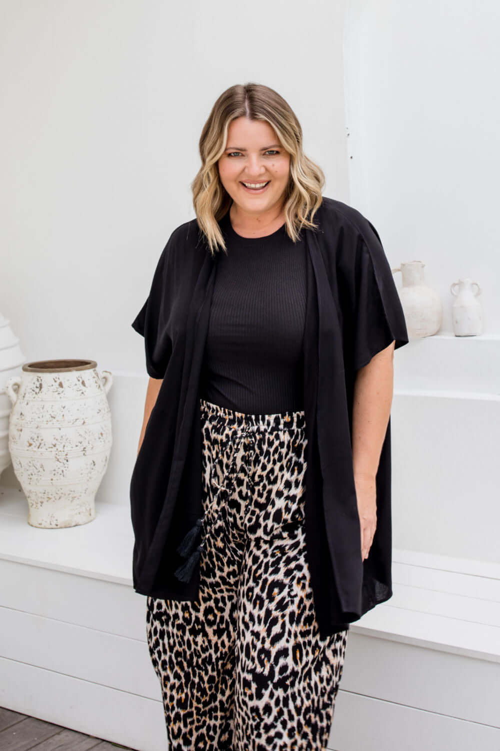 Front view of black kimono cape with relaxed open drape