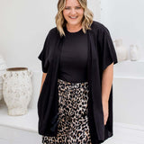 Front view of black kimono cape with relaxed open drape