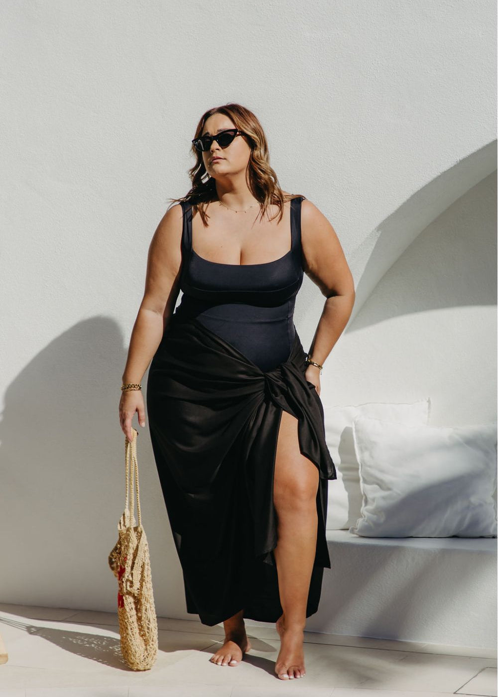lady wearing black sarong poolside