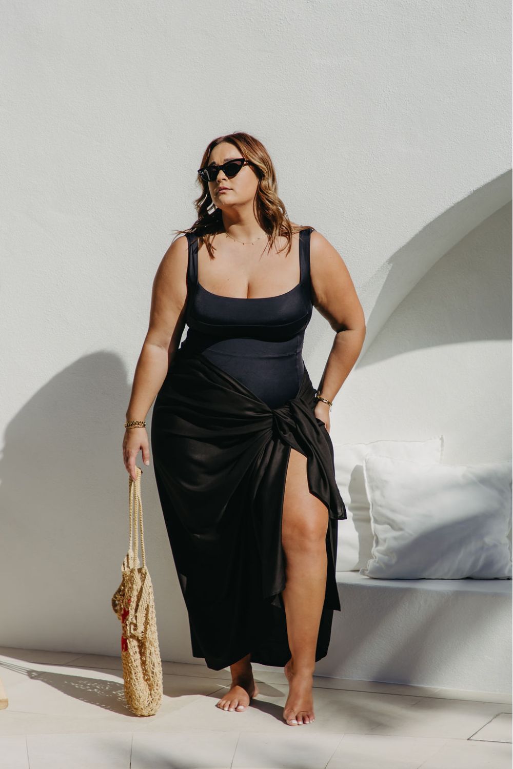 lady wearing black sarong poolside