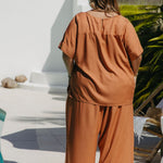 Back view of Kate wearing Mocha Mousse Blouse Co-Ord Set size XL showing full drape of blouse and tunic-length fall over wide-leg pants