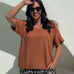 Woman wearing a mocha mousse brown top and relaxed fit leopard print pants poolside