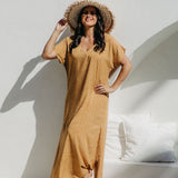 Angled view of the Caramel Scatter Dot Maxi Dress showing relaxed fit on SM model