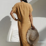 Back view of the maxi dress highlighting flowing kaftan cut on SM curve model