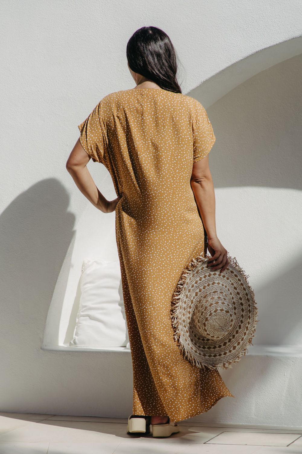 Back view of the maxi dress highlighting flowing kaftan cut on SM curve model
