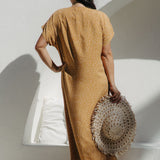 Back view of the maxi dress highlighting flowing kaftan cut on SM curve model