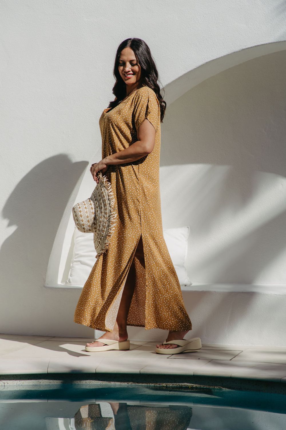 Side view showing side splits of Caramel Scatter Dot Maxi Dress on size SM model