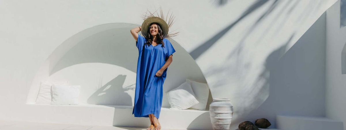 Mature model wearing DeJaVu blue A-line maxi resort dress on outdoor deck