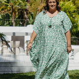 Woman walking outdoors in emerald green Sorrento print kaftan – resort wear