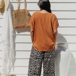 Back view of Alisha wearing Mocha Mousse Kaftan Top size S/M – draped over leopard pants