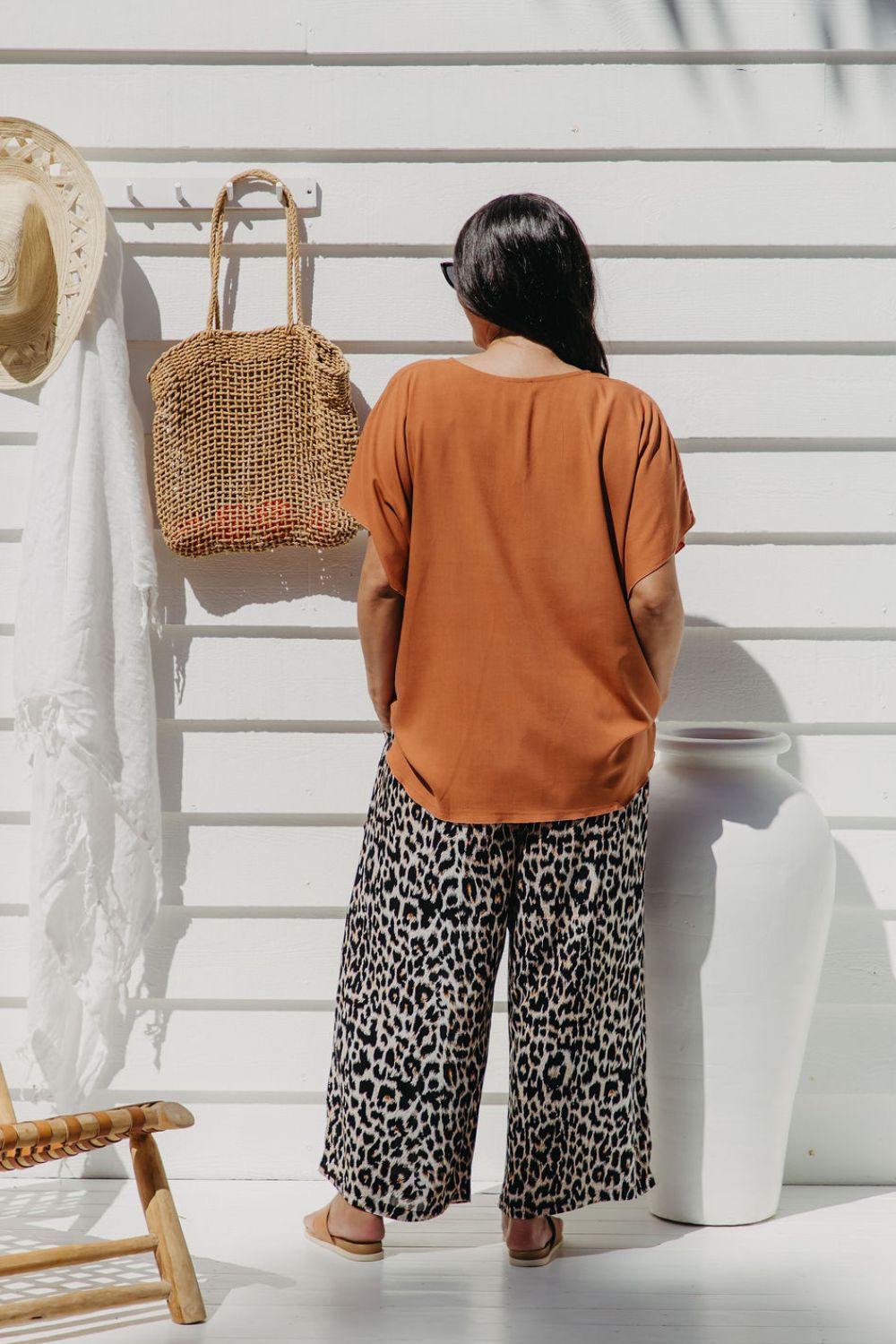 Back view of Alisha wearing Mocha Mousse Kaftan Top size S/M – draped over leopard pants