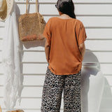 Back view of Alisha wearing Mocha Mousse Kaftan Top size S/M – draped over leopard pants