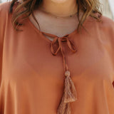 Close-up of Mocha Mousse Kaftan Top fabric on Kate showing rust-brown colour tone