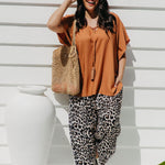 Alisha wearing Mocha Mousse Kaftan Top size S/M with leopard pants, sunglasses and tote bag – front view, relaxed weekend market outfit
