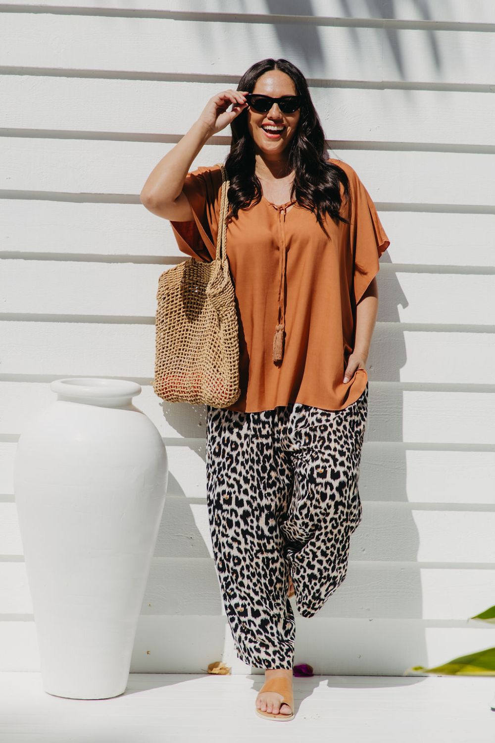 Alisha wearing Mocha Mousse Kaftan Top size S/M with leopard pants, sunglasses and tote bag – front view, relaxed weekend market outfit