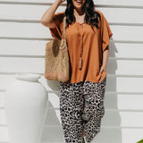 Alisha wearing Mocha Mousse Kaftan Top size S/M with leopard pants, sunglasses and tote bag – front view, relaxed weekend market outfit