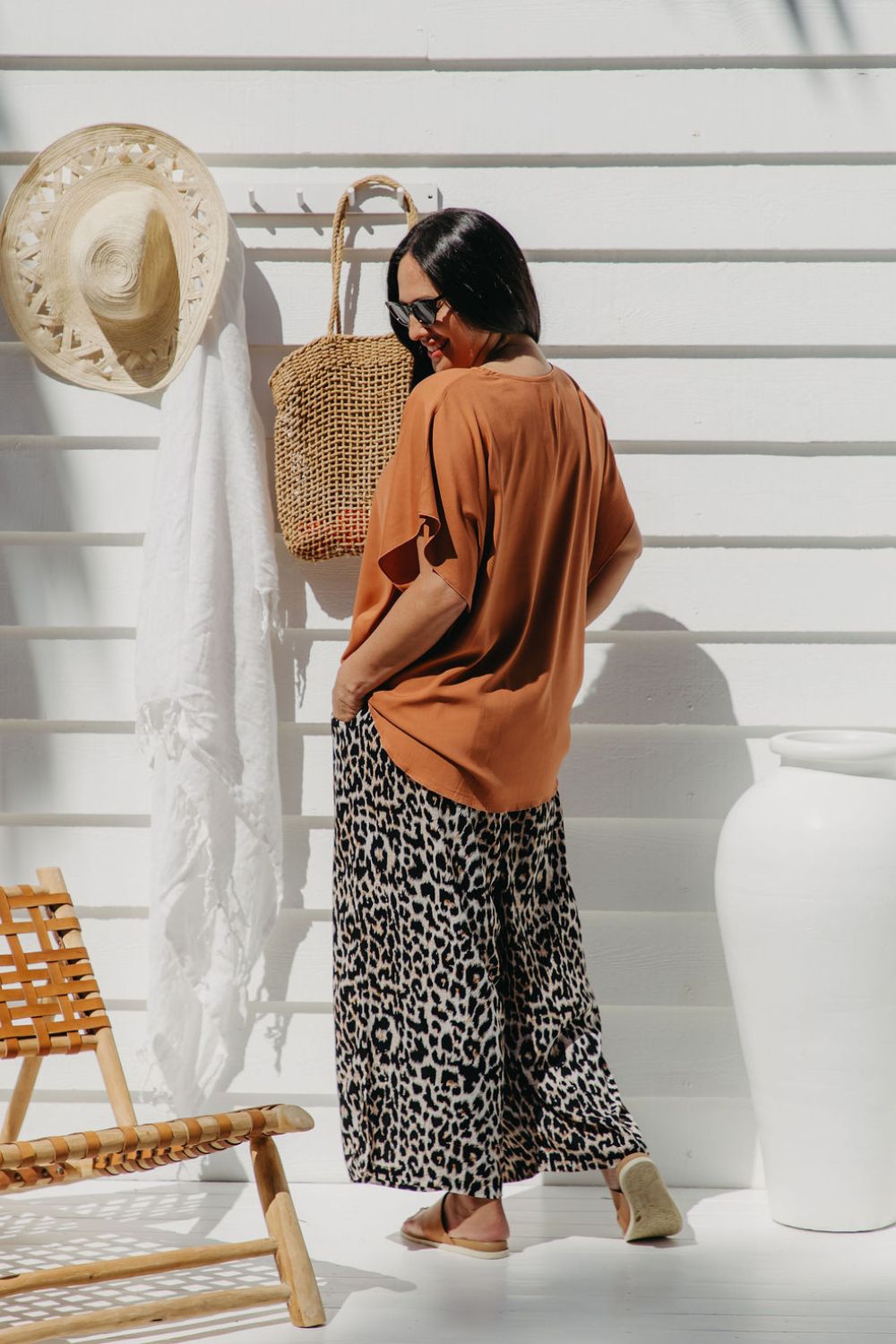 Partial back view of Alisha wearing Mocha Mousse Kaftan Top size S/M – showing drape and length