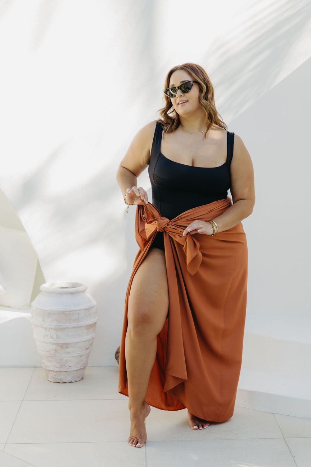 Kate wearing XL fringeless sarong in Mocha Mousse, front view showing ample fabric for a secure tie, poolside on a sunny day