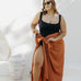 Kate wearing XL fringeless sarong in Mocha Mousse, front view showing ample fabric for a secure tie, poolside on a sunny day