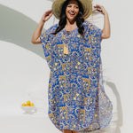 Woman wearing Long Summer kaftan dress called Limoncello poolside in seaside resort