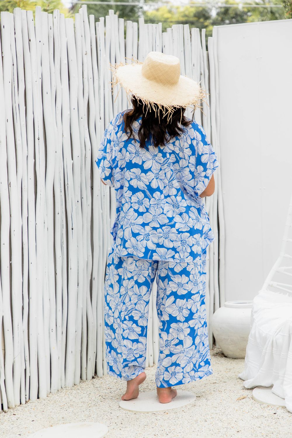 lady wearing a blue floral kaftan top with matching Palazzo pants at poolside resort