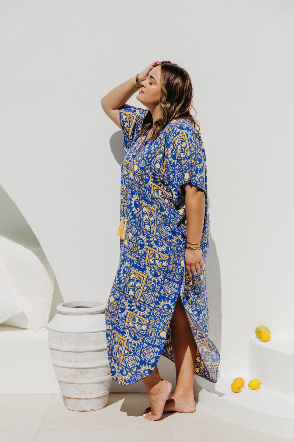 Plus Size woman wearing long kaftan dress with blue and yellow limoncello print for summer holiday