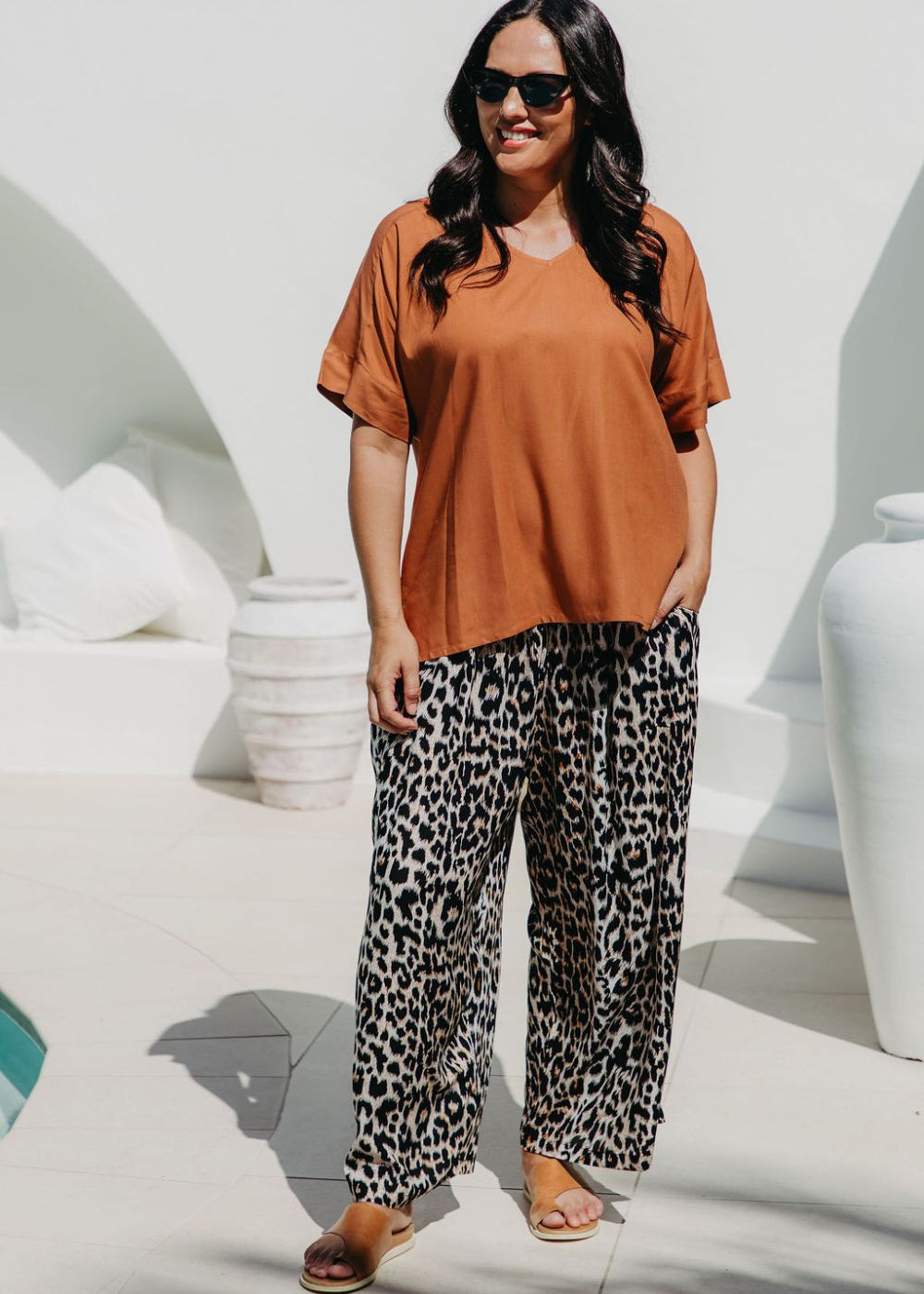 Woman wearing an casual summer top and leopard print relaxed fit pants for weekend outing