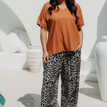 Woman wearing an casual summer top and leopard print relaxed fit pants for weekend outing