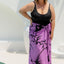 Woman wearing a purple floral sarong poolside for summer