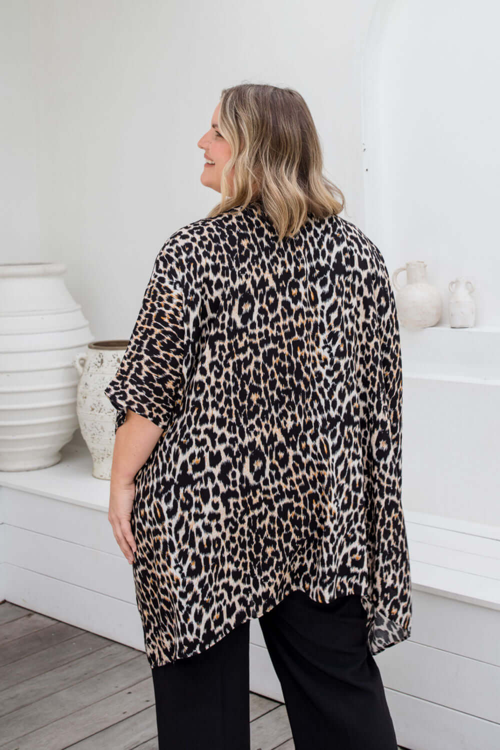 Back view of leopard print kimono cape showing below-hip length